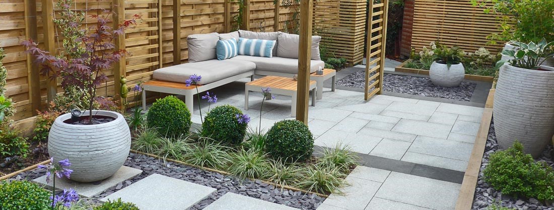 Urban Sanctuary: contemporary ‘no lawn’ garden with an Outdoor Lounge, topiary balls, and statement pots