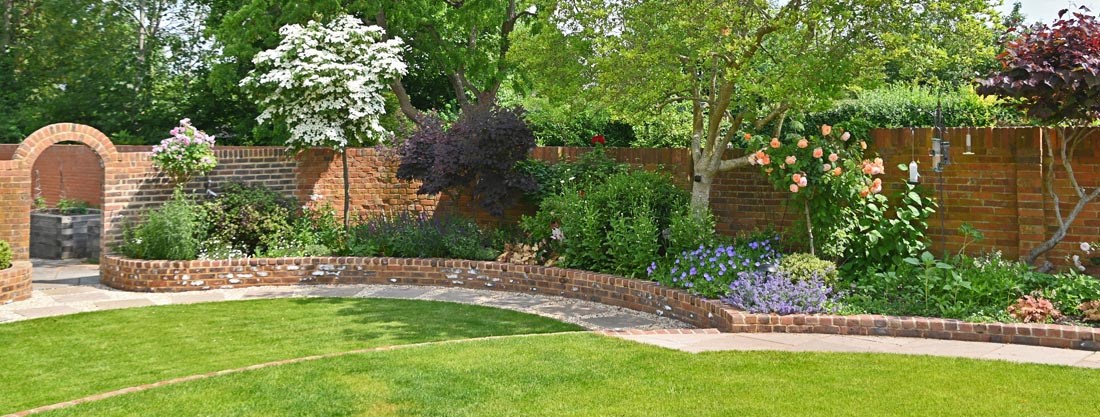 Timeless Walled Garden with a mixed shrub and perennial cottage border