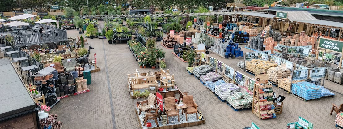Longacres Bourne Valley aerial view of the outside of the store showing the stoneware department, shrubs and outdoor cafe seating area