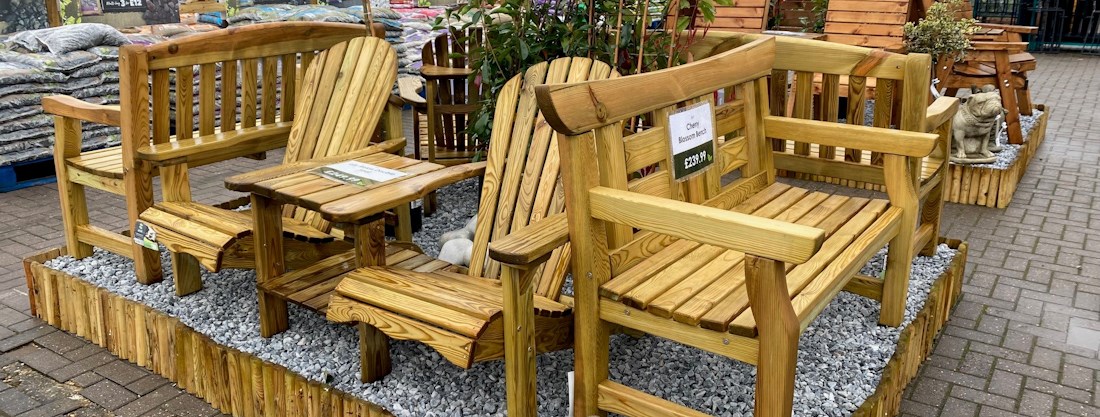 Longacres Bourne Valley wooden outdoor furniture display with wooden benches and companion seating