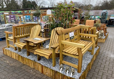 Longacres Bourne Valley wooden outdoor furniture display with wooden benches and companion seating