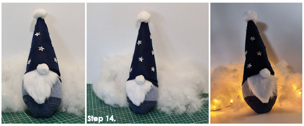 Image of the finished gonk with stars on his hat as decoration and surround by warm white fairy lights