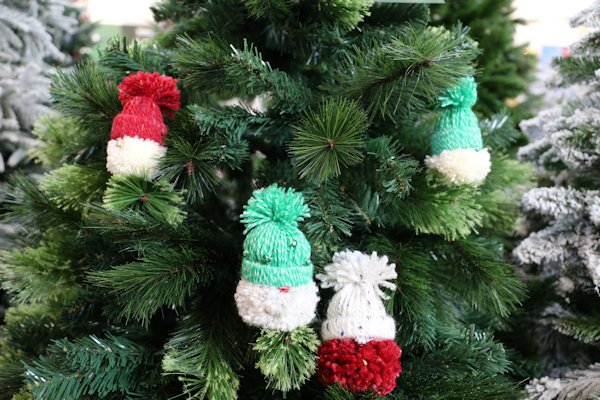 festive pom-pom wool gonks sat upon an artificial tree