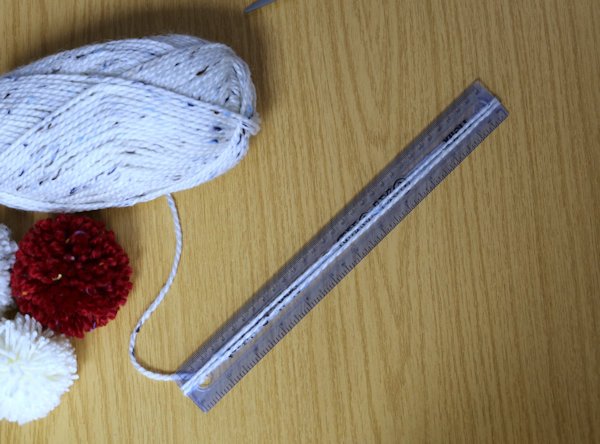 wrapping wool around a ruler to measure the lengths