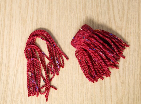 a cardboard tube fully wrapped with wool