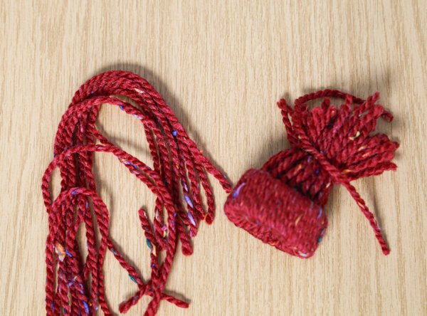 securing the stands of wool and creating the top of the hat